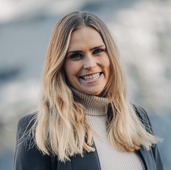 Portrait of Livia Altmann in beige turtleneck and grey blazer